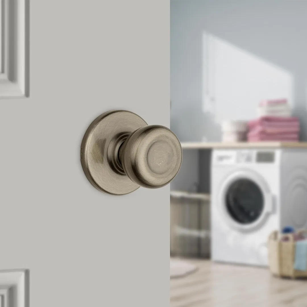 Kwikset Tylo Passage Door Knob, Antique Brass, ANSI/BHMA Grade 3, Fits 1-3/8–1-3/4 in Doors, photo 2 of 8